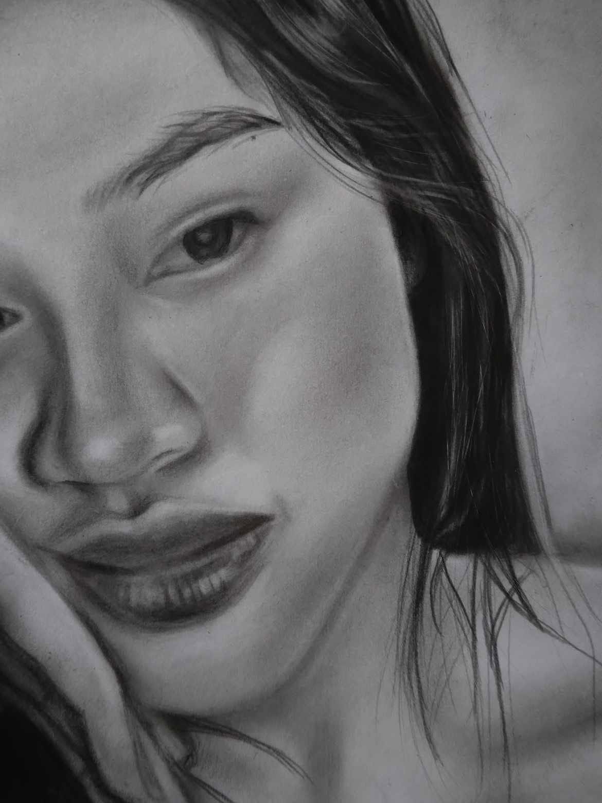 A detailed graphite close-up portrait drawn by Precious Angel Lopez
